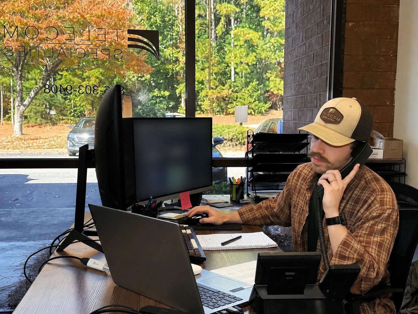 Telecom Specialties team member assisting a customer by phone